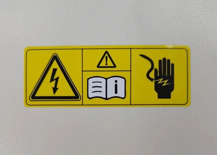 Warning label for automotive wireless charger cover plates